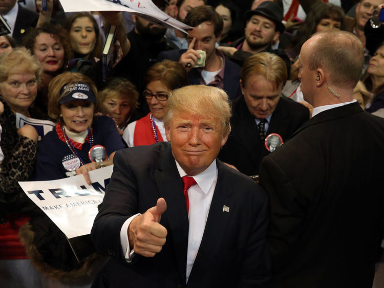  Le partisan présidentiel républicain Donald Trump fait une pause avec les supporters après avoir parlé au Colisée de la côte du Mississippi le 2 janvier 2016 à Biloxi, Mississippi 