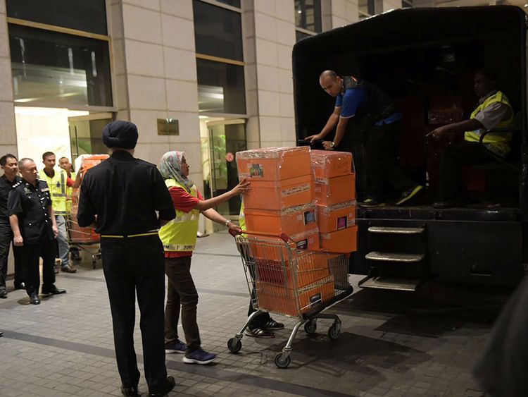 La police enlève des caisses de l'un des appartements de Najib Razak