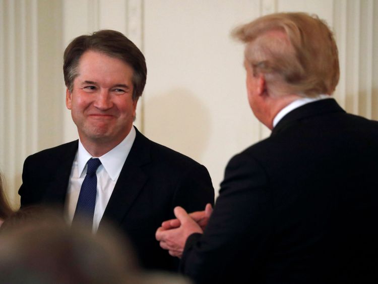 Le juge Brett Kavanaugh, candidat à la Cour suprême, sourit aux côtés du président américain Donald Trump dans la pièce de la salle blanche à Washington
