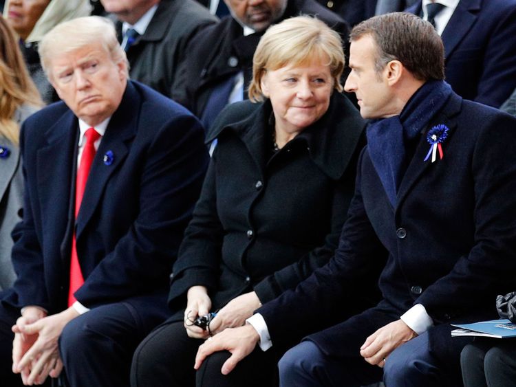 Le président français Emmanuel Macron (à droite) touche le genou de la chancelière allemande Angela Merkel (à droite), assis aux côtés du président américain Donald Trump (à gauche) et de la première dame américaine Melania Trump (à gauche) lors d'une cérémonie à l'Arc de Triomphe à Paris le 11 novembre 2018 dans le cadre des commémorations du 100e anniversaire de l'armistice du 11 novembre 1918, mettant fin à la Première Guerre mondiale