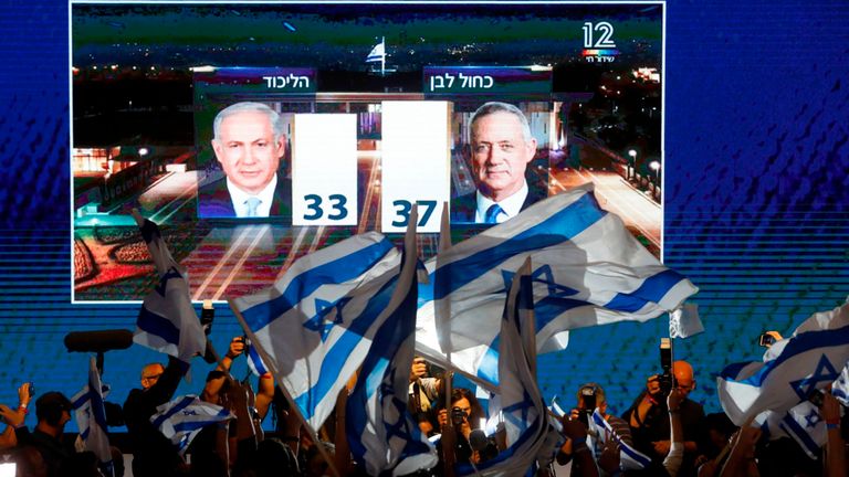 Les partisans de l'alliance bleue et blanche agitent des drapeaux à la sortie des urnes