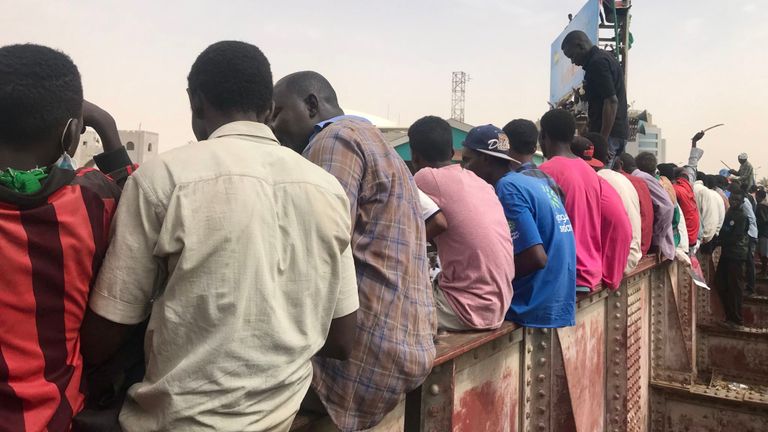 hommes assis sur un pont de chemin de fer lors d'une manifestation d'un million d'hommes