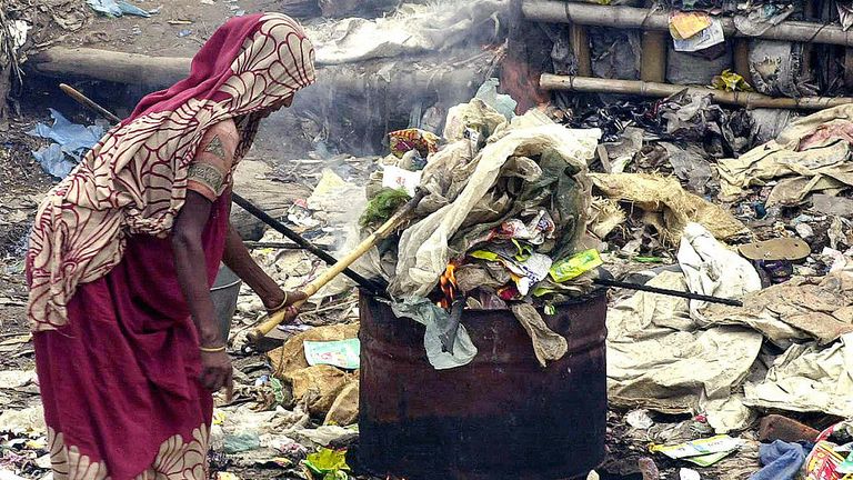 DHAKA, BANGLADESH: Une travailleuse bangladaise brûle des ordures alors qu'elle travaille dans une usine de recyclage de plastique dans le district de Rasulpur à Dhaka, le 15 septembre 2005. 