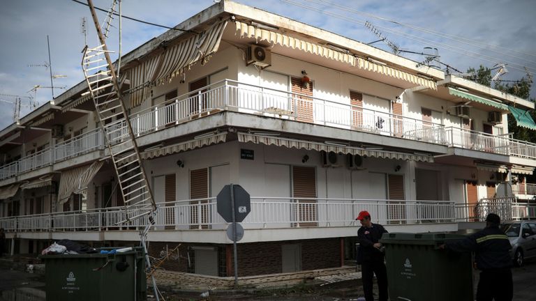 Les pompiers portent une poubelle à côté de débris à la suite de fortes tempêtes dans le village de Nea Plagia, en Grèce, le 11 juillet 2019. REUTERS / Alkis Konstantinidis