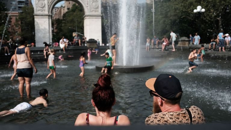 Les gens essaient de rester cool dans la fontaine à Washington Square Park