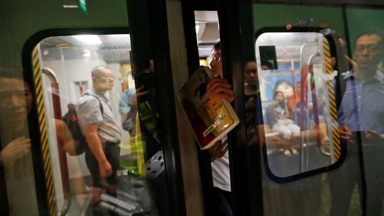 Un manifestant empêche les portes d'un train de se fermer