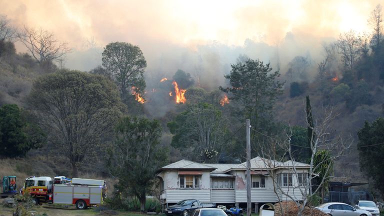 Équipes d'incendie et d'urgence combattant un feu de brousse près d'une maison de la ville rurale de Canungra, dans la région de Scenic Rim, dans le sud-est du Queensland, en Australie, le 6 septembre 2019