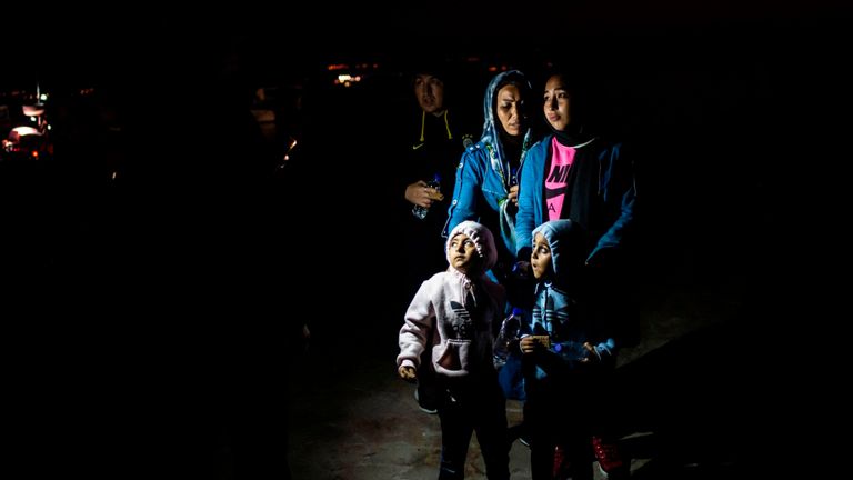 TOPSHOT - Les migrants attendent d'embarquer dans un bus alors qu'ils sont transférés dans un camp à la suite d'une opération de sauvetage menée par un navire de surveillance Frontex, dans le port de Skala Sikamias, sur l'île de Lesbos, le 2 octobre 2019. - Le pêcheur Christos Halkiotis à le village de Skala sur l'île grecque de Lesbos accorde peu d'attention à la répression promise par le gouvernement grec afin de freiner la montée des flux migratoires. "Tout dépend des Turcs", a déclaré Halkiotis en dénouant calmement ses lignes et en s'accrochant dans un seau. "Ce sont eux qui laissent