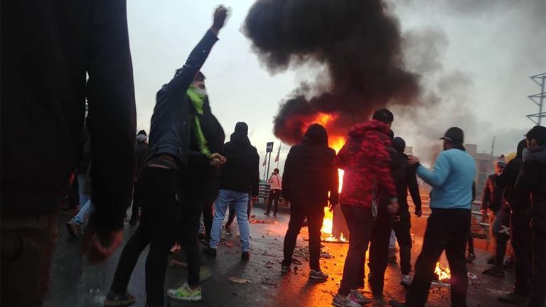 Des manifestants iraniens se rassemblent autour d'un feu lors d'une manifestation contre l'augmentation du prix de l'essence dans la capitale, Téhéran, le 16 novembre 2019.
