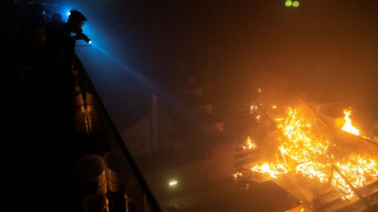Des manifestants antigouvernementaux se profilent à l'Université polytechnique de Hong Kong (PolyU) lors d'un incendie à Hong Kong, Chine, le 18 novembre 2019