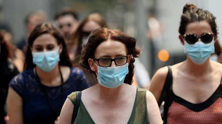 Les gens portent des masques pour se protéger de la brume de fumée à Sydney, en Australie, le 5 décembre