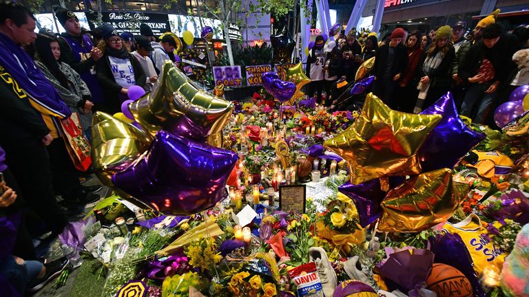 Les gens se rassemblent devant un mémorial de fortune pour l'ancien joueur de la NBA et des Lakers de Los Angeles Kobe Bryant et sa fille Gianna Bryant, qui ont été tués avec sept autres personnes dans un accident d'hélicoptère le 26 janvier, à LA Live plaza en face du Staples Center de Los Angeles le 27 janvier 2020. - Des enquêteurs fédéraux ont passé au crible l'épave de l'accident d'hélicoptère qui a tué la légende du basket-ball Kobe Bryant et huit autres personnes, dans l'espoir de trouver des indices sur la cause de l'accident qui a stupéfait le monde. (Photo par FREDERIC J. BROWN / AFP) (Photo par FREDERIC J. BROWN / AFP via Getty Images)