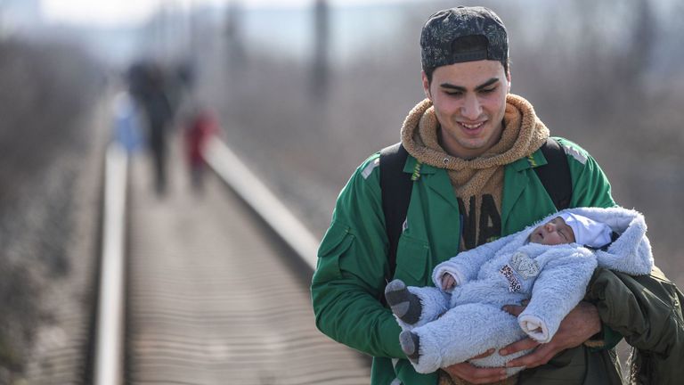Un migrant porte son bébé