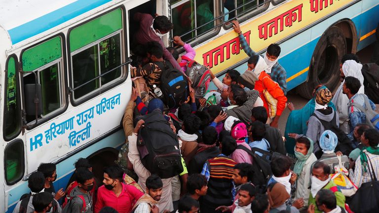 Les travailleurs migrants montent à bord des bus