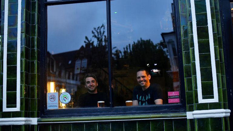 Dominic Townsend et Steve Pond dégustent une pinte de bière en regardant le Prince, un pub qu'ils partagent un appartement au-dessus et disent avoir la chance d'être coincé pendant le verrouillage alors que la maladie à coronavirus (COVID-19) continue à Londres, en Grande-Bretagne 28 avril 2020. Photo prise le 28 avril 2020. REUTERS / Dylan Martinez