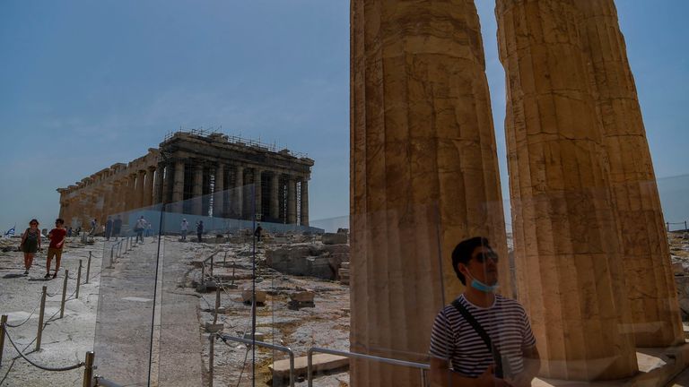 Un touriste visite le temple du Parthénon sur le site archéologique de l'Acropole à Athènes, Grèce