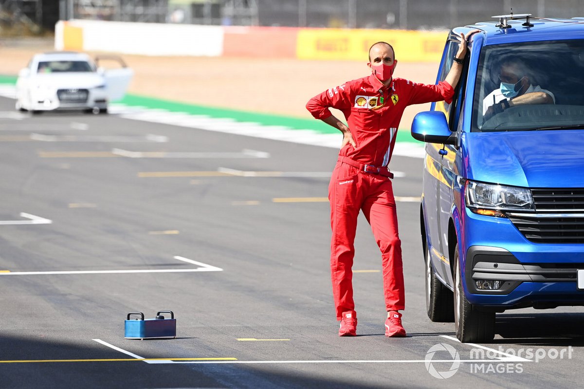 Un membre de l'équipe Ferrari se tient sur la grille