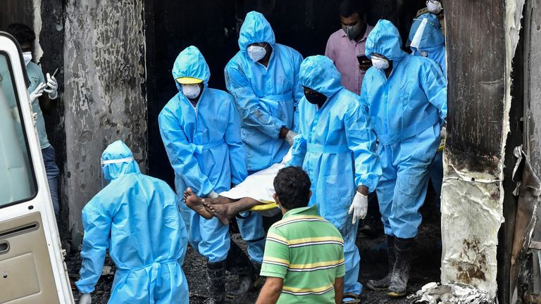 Les secouristes transportant le corps d'un patient mort dans l'incendie