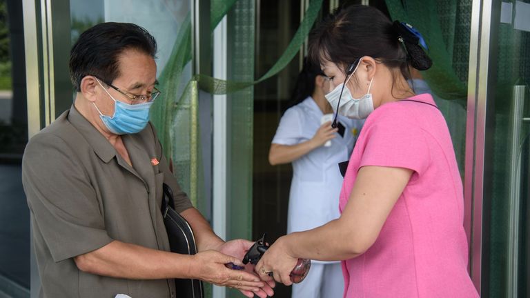 Un visiteur reçoit un désinfectant pour les mains lorsqu'il entre dans le complexe de santé Ryugyong à Pyongyang