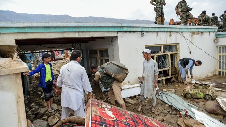 Les villageois nettoient les débris de leurs maisons à la suite de fortes pluies dans la province afghane de Parwan