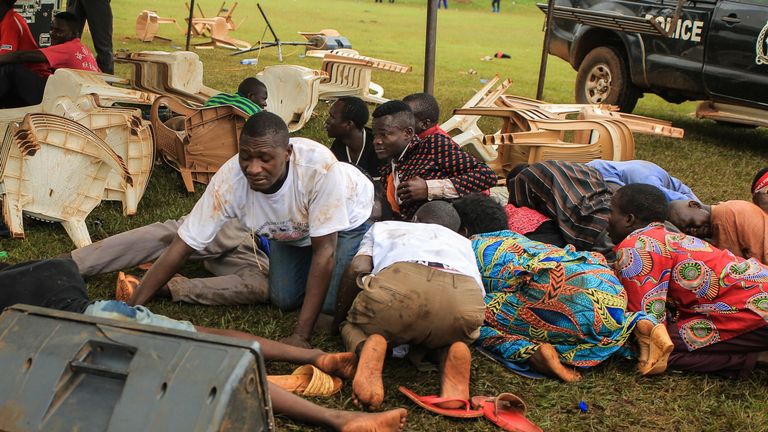Les partisans de Bobi Wine se mettent à l'abri des gaz lacrymogènes tirés par la police lors d'un rassemblement 