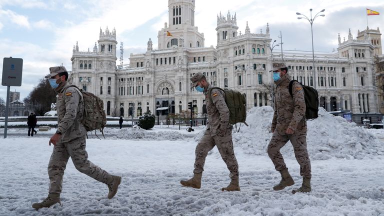 Des militaires passent devant la fontaine de Cibeles et le bâtiment de l'hôtel de ville après une forte chute de neige à Madrid, en Espagne, le 10 janvier 2021. REUTERS / Susana Vera
