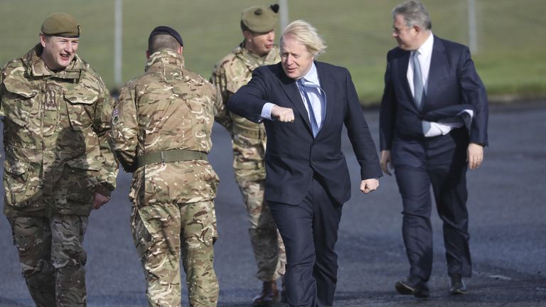   Le Premier ministre Boris Johnson accueille les troupes aux côtés du secrétaire d'Irlande du Nord Brandon Lewis (à droite) et du brigadier Chris Davies, commandant de la 38e Brigade (irlandaise) (à gauche), lors d'une visite à la station de vol Joint Helicopter Command d'Aldergrove en Irlande du Nord